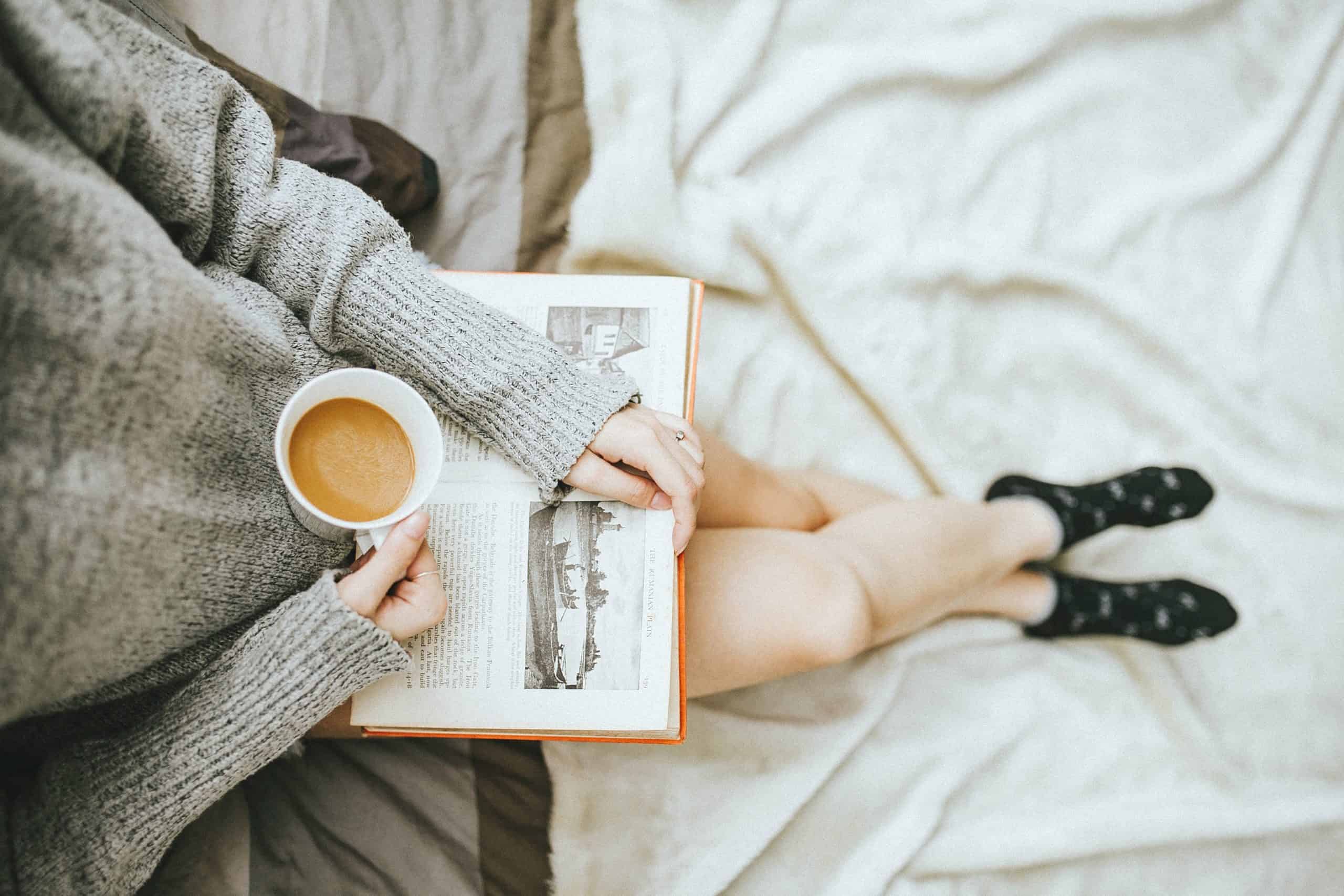 kobieta czytająca kubek kawy książka